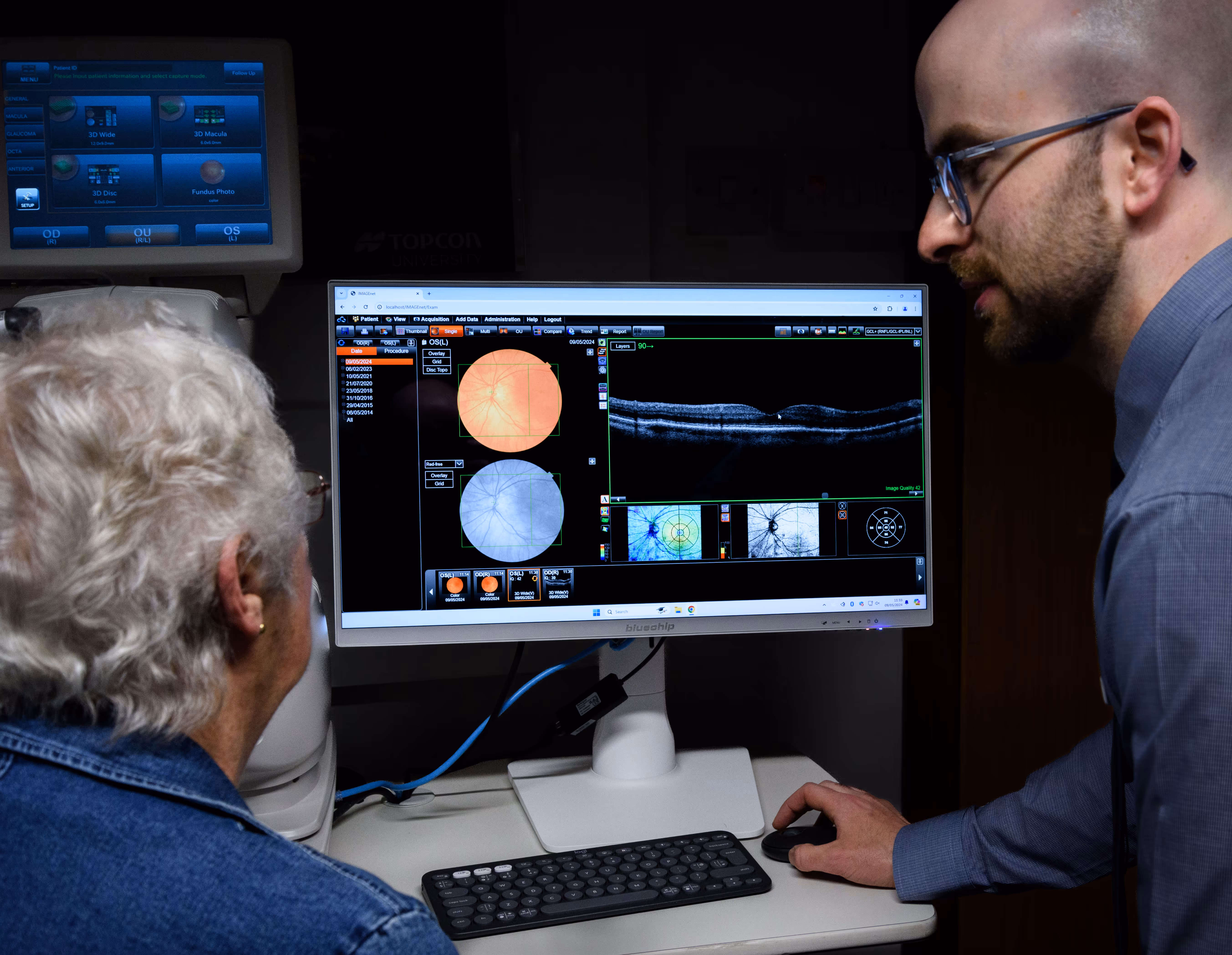 Medical professionals examining eye scans on computer monitor