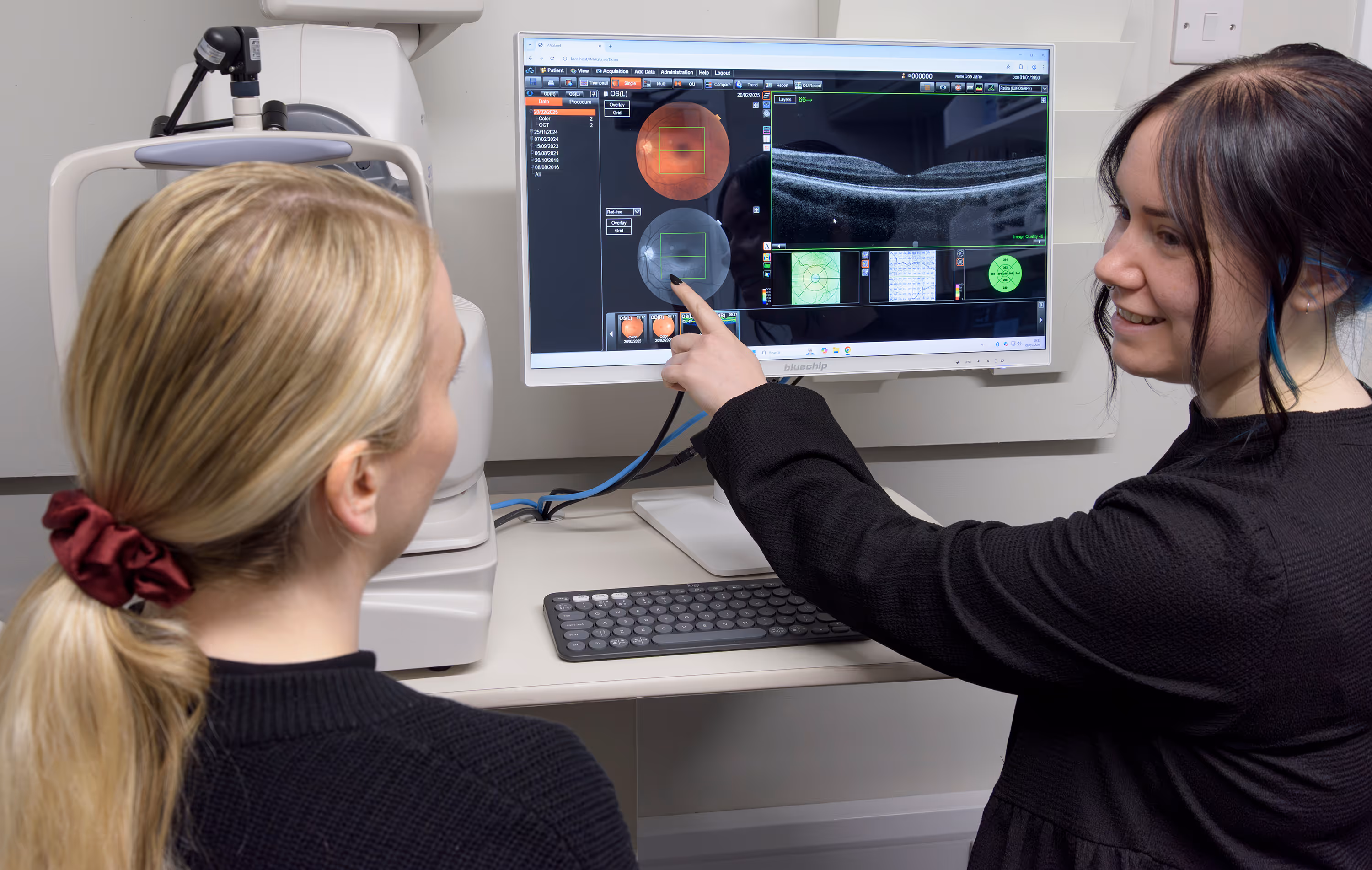Medical professionals reviewing eye scan images on computer screen