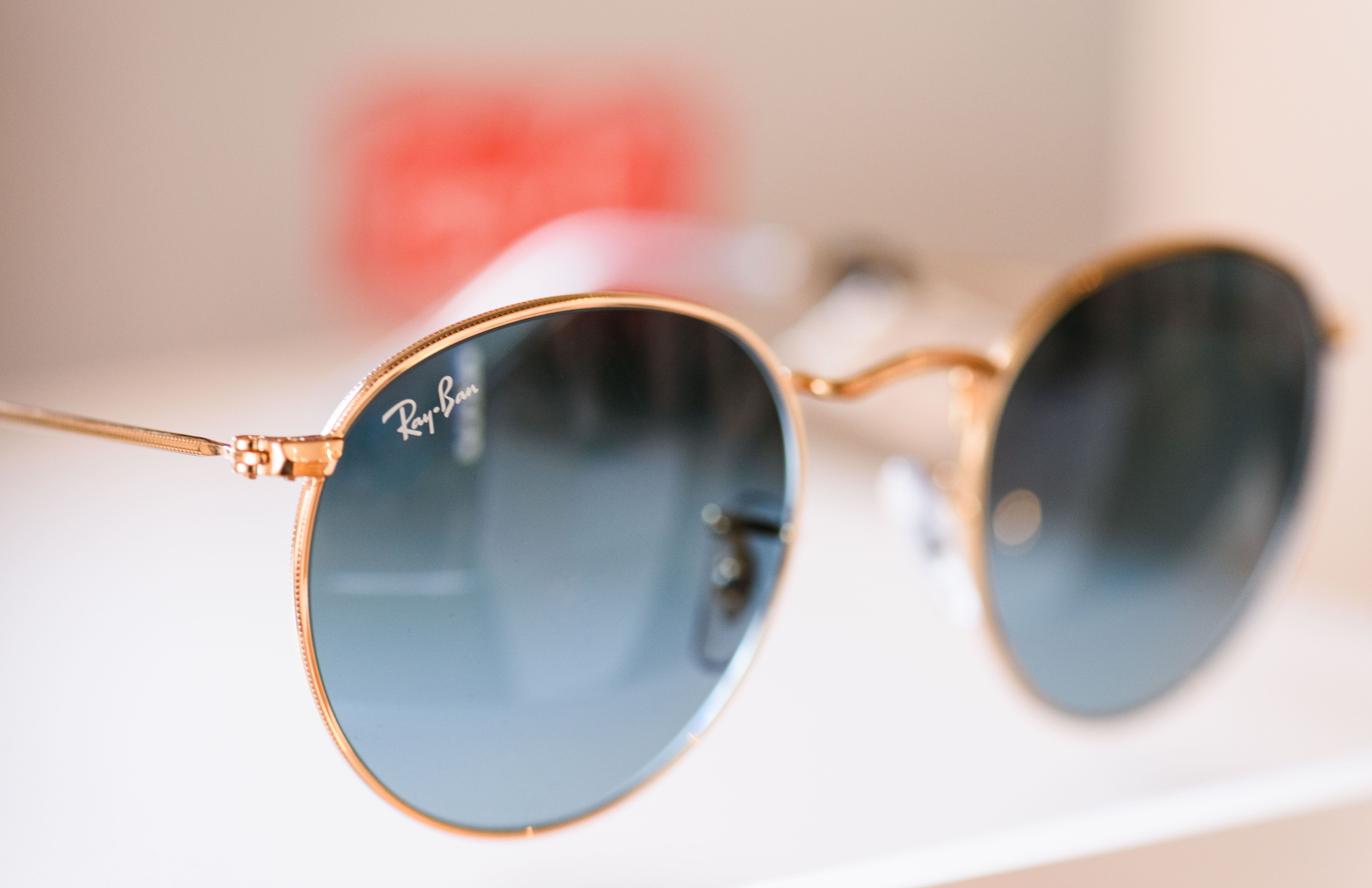 Gold-rimmed Ray-Ban round sunglasses with blue gradient lenses