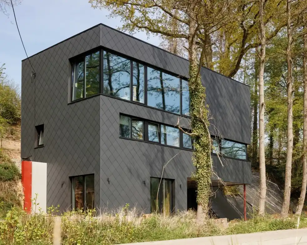 Moderne woning volledig bekleed met donkere vezelcementleien, gerealiseerd door Energy Protect.