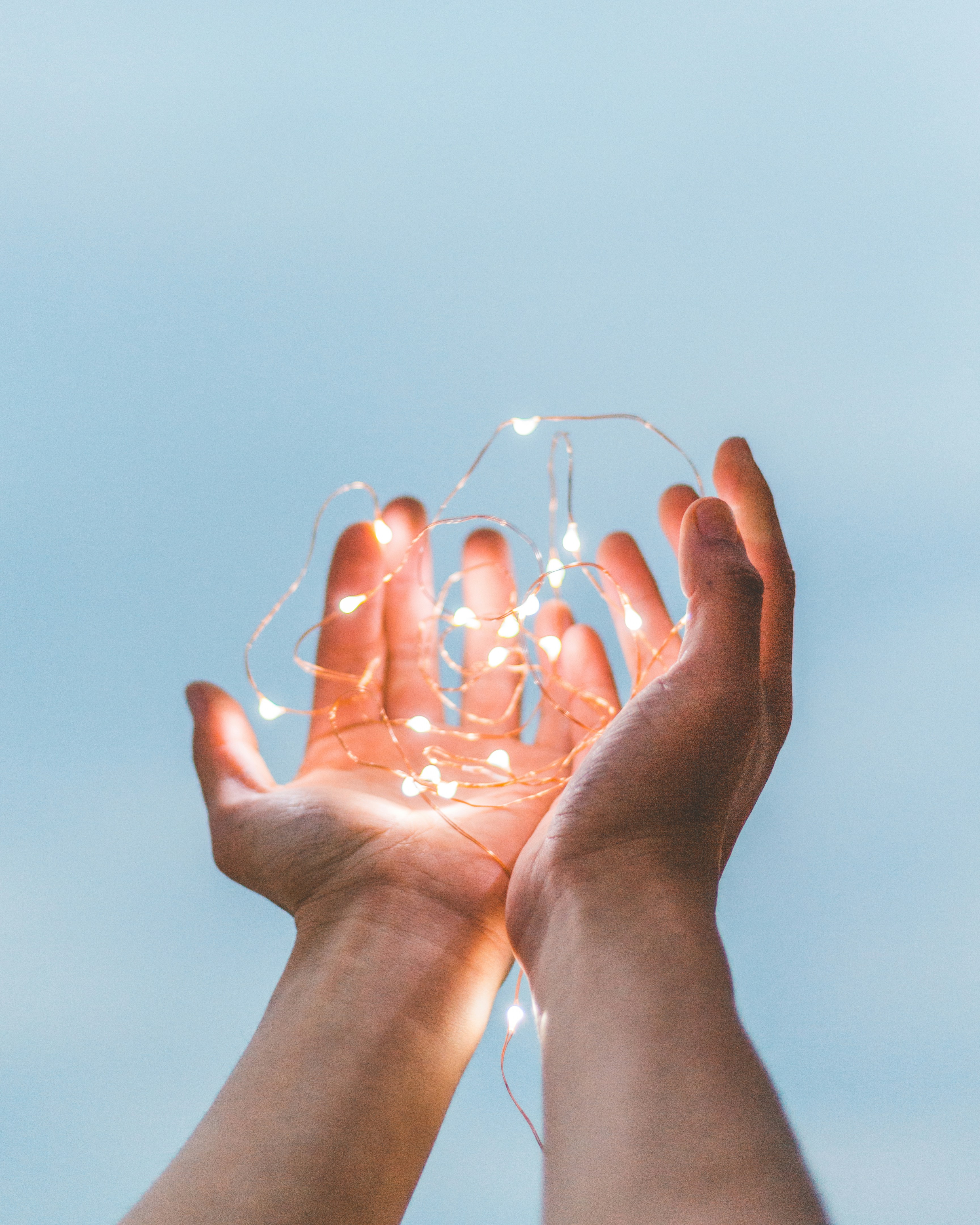 hands holding up lights