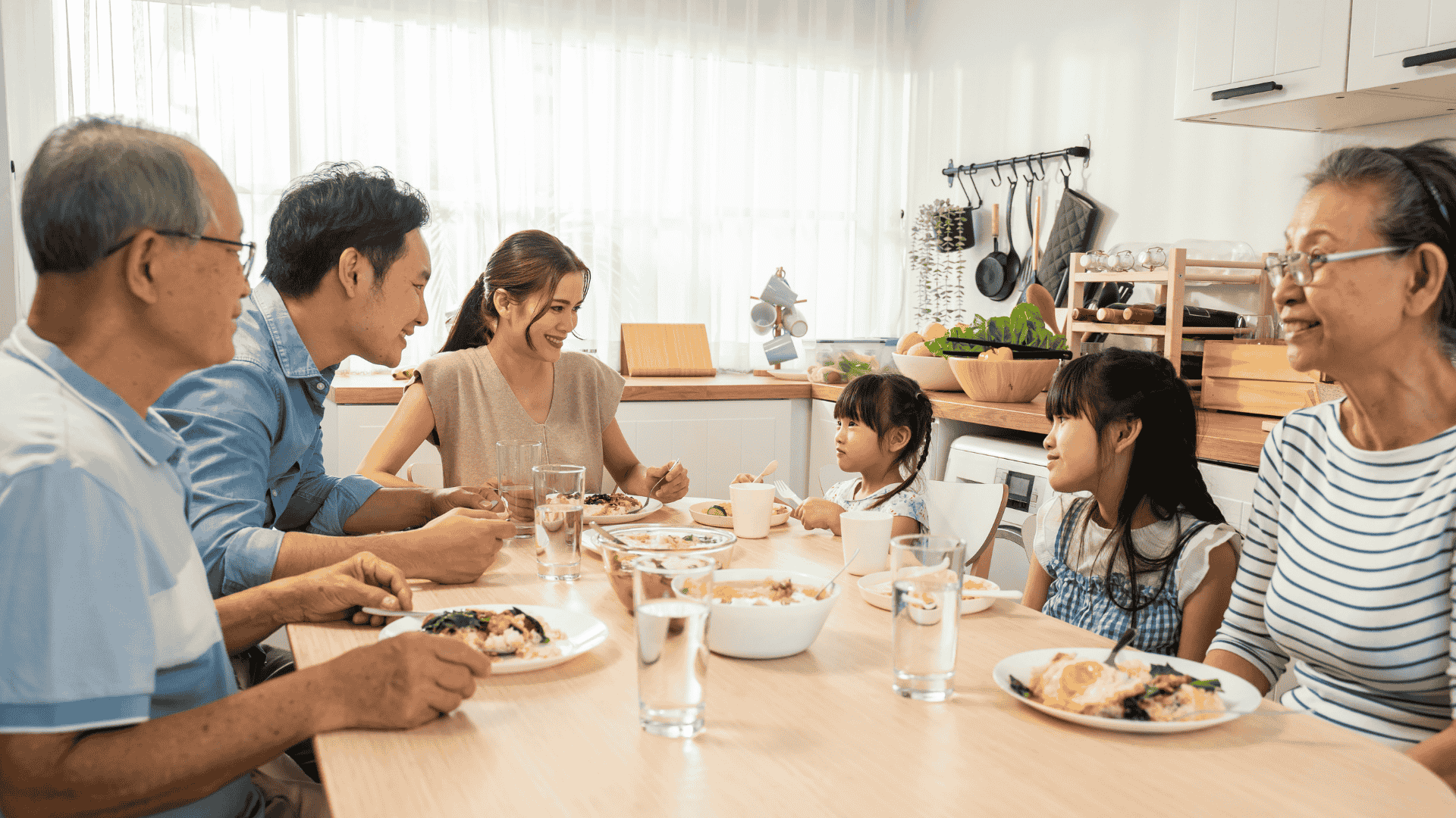 Happy family sharing a meal together at the dinner table, enjoying quality time and healthy food – The Laughing Broccoli