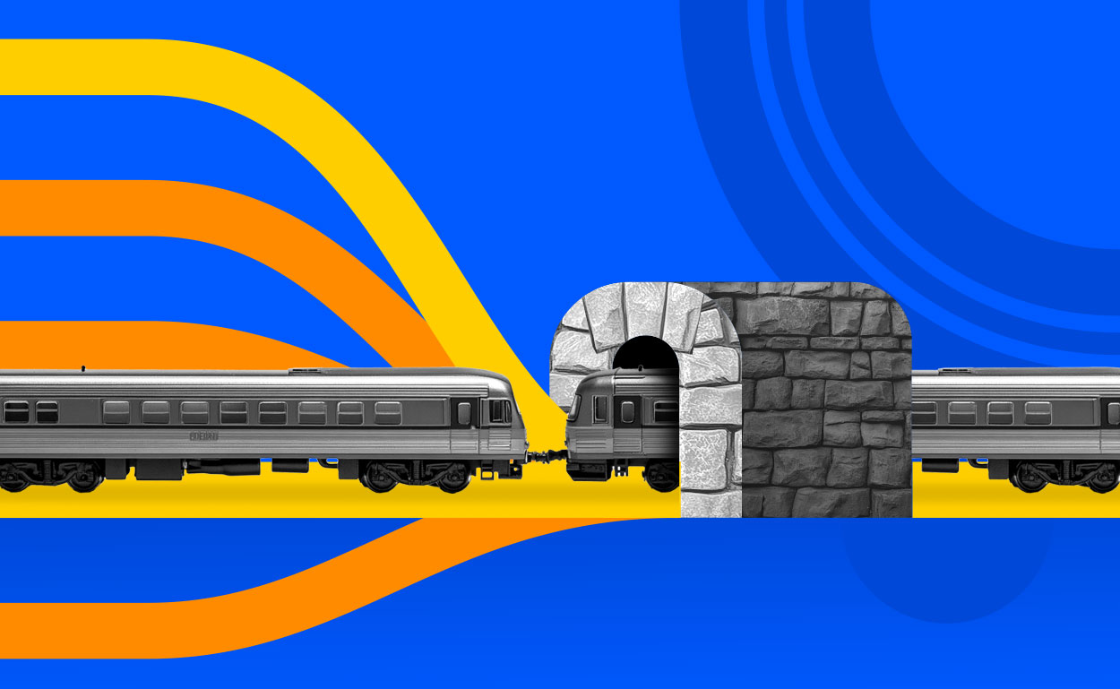 Many train tracks entering tunnel
