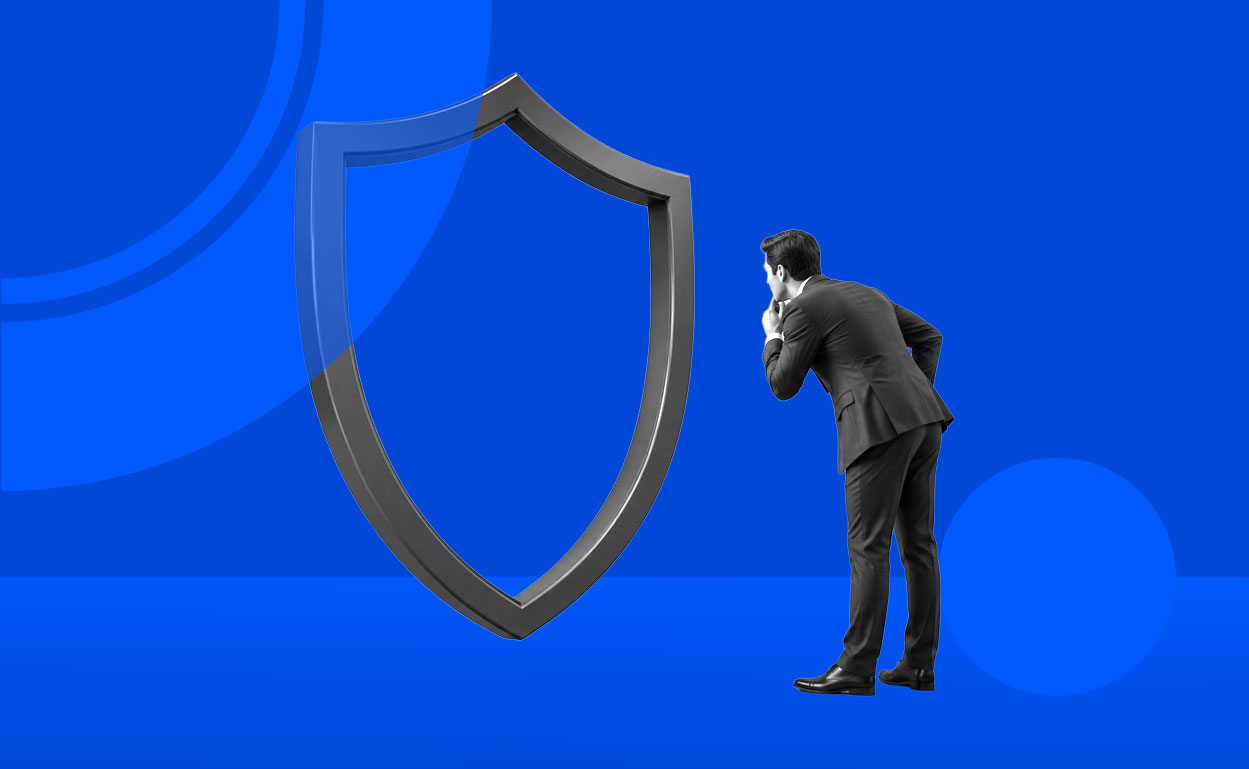 Businessman looking into an empty shield-shaped frame
