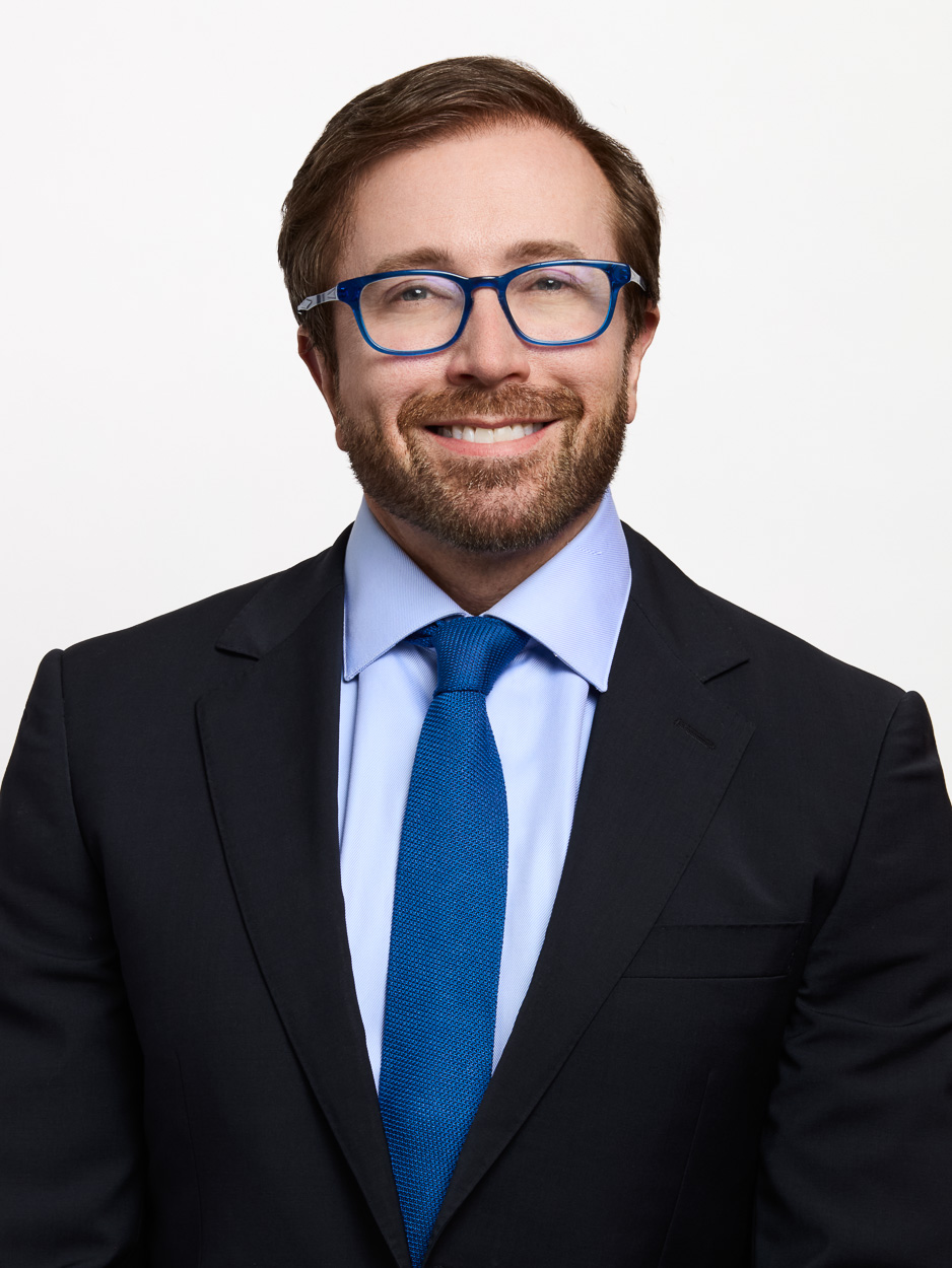 The superintendent with glasses, dressed in a blue suit.