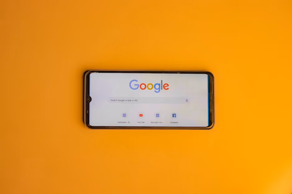 Smartphone displaying Google search page on a vibrant yellow background.. Photo by Shantanu Kumar on Pexels
