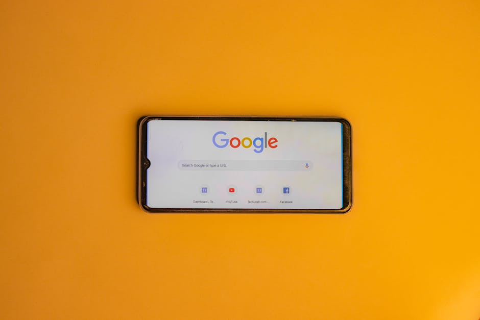 Smartphone displaying Google search page on a vibrant yellow background.. Photo by Shantanu Kumar on Pexels