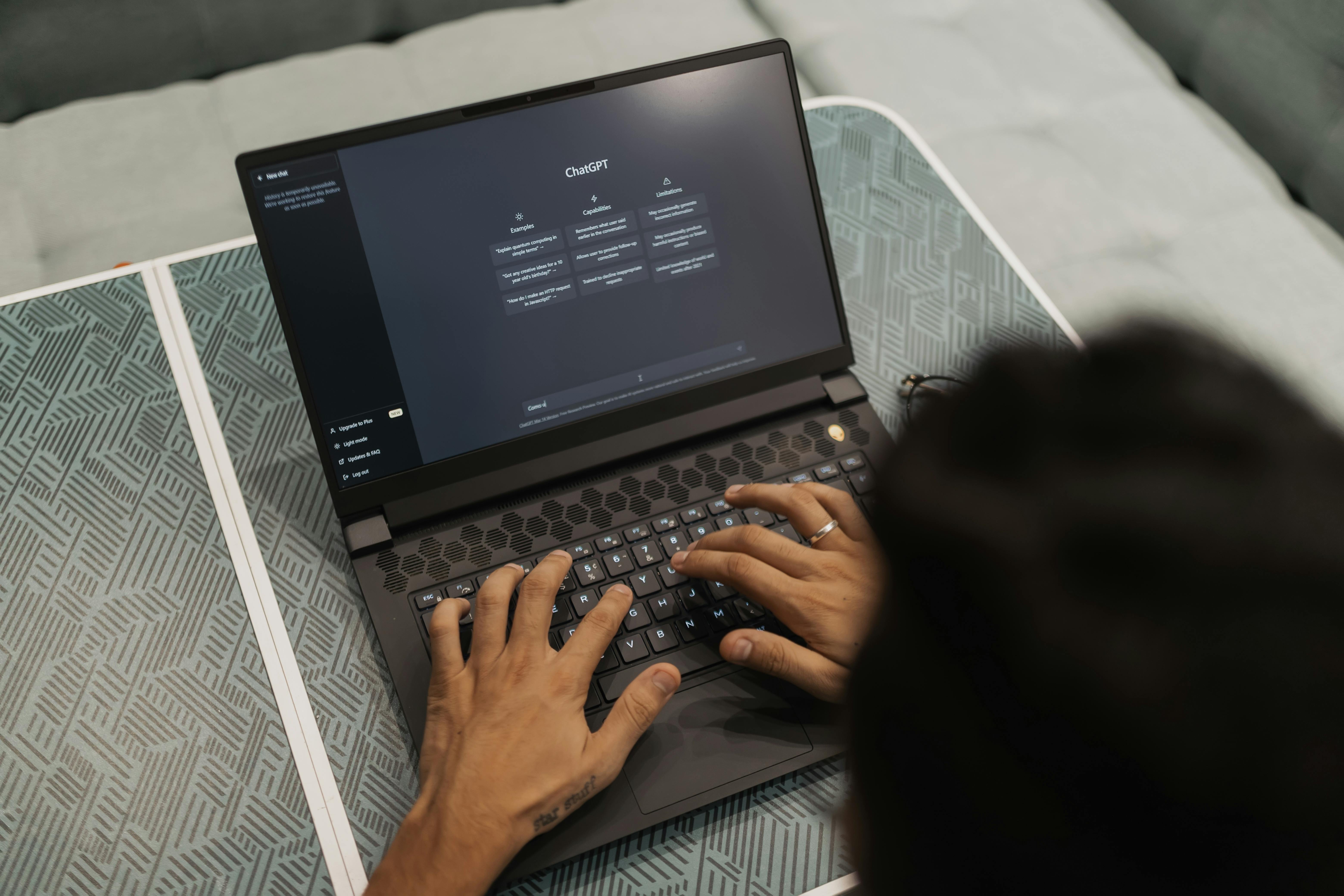 Person using ChatGPT on a laptop for AI-assisted copywriting