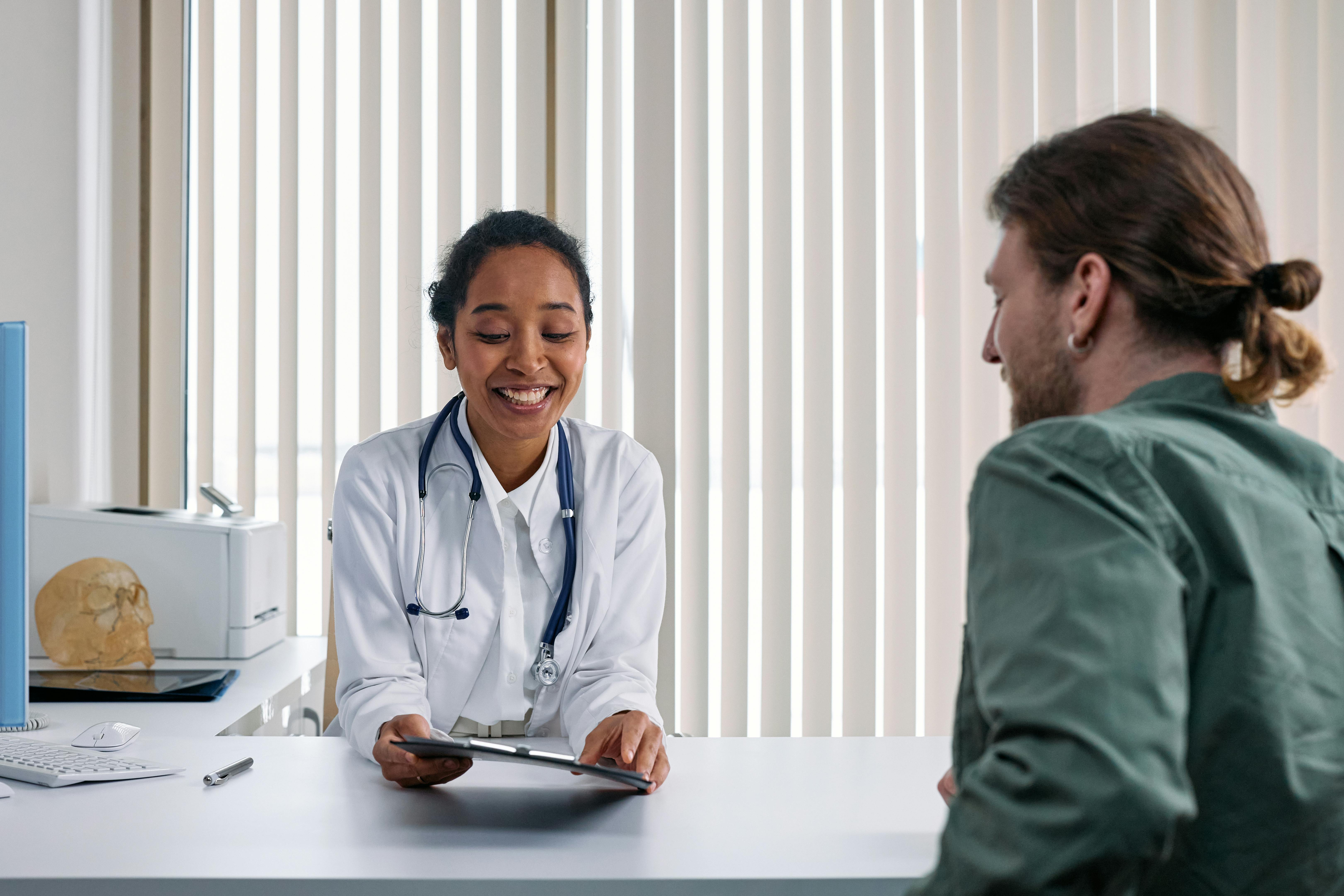 Doctor using a tablet during a patient consultation in a medical office