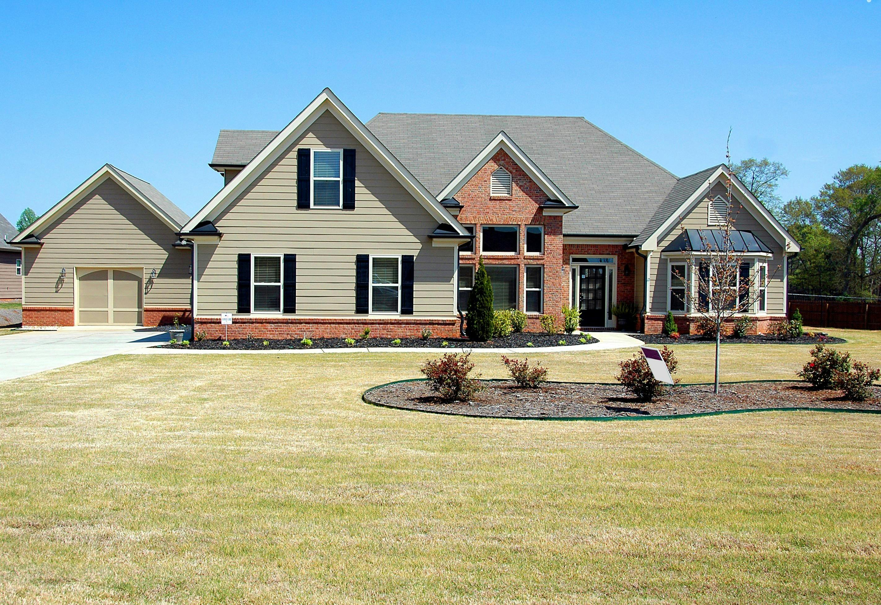 Suburban New Jersey home with prominent residential roof on a clear day