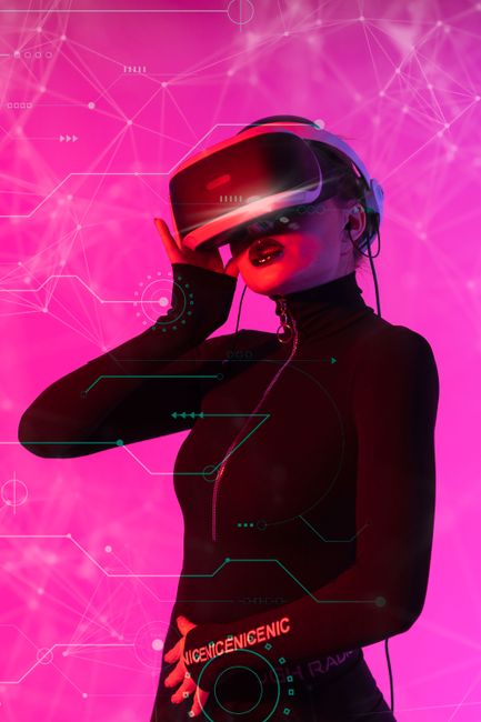 Woman wearing VR headset in a futuristic digital environment with pink cyber graphics.. Photo by Atlantic Ambience on Pexels