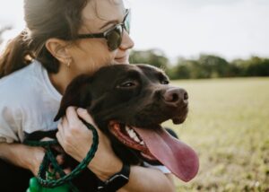 human hugging happy dog