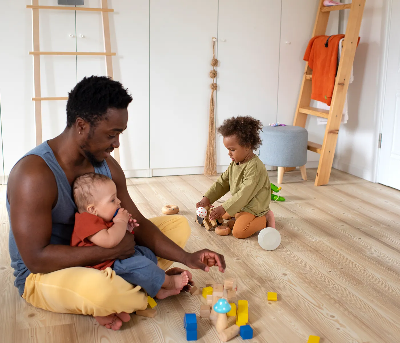 Father playing with young children at home supporting child development and family wellbeing