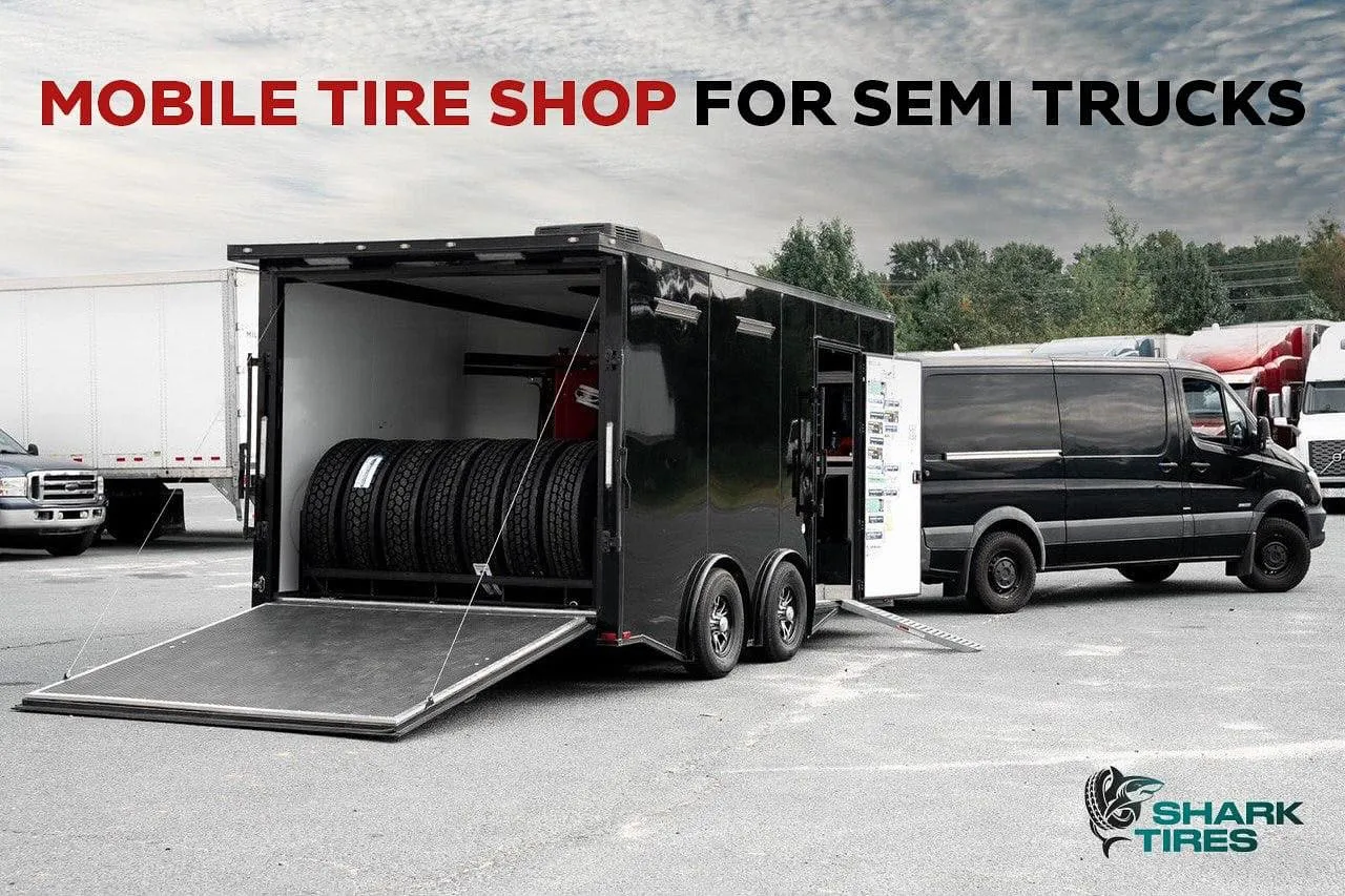 A mobile tire shop with a ramp, stocked with semi truck tires, parked in a lot beside other vehicles.