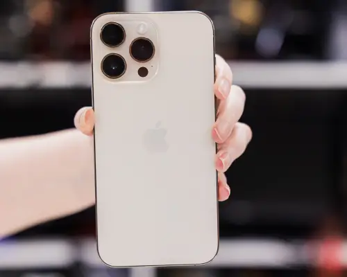 An image of a person holding an iPhone inside of a data recovery lab.