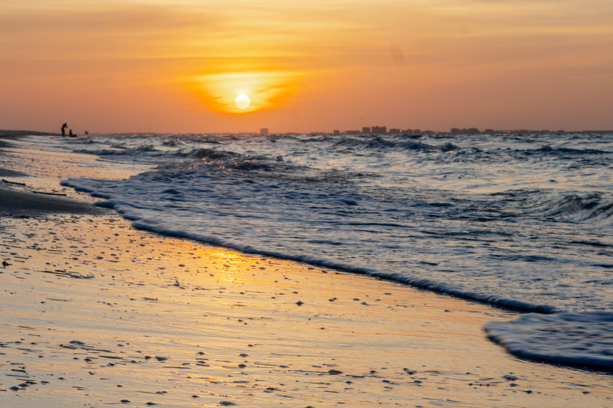 Fiery sunset with waves at the shoreline