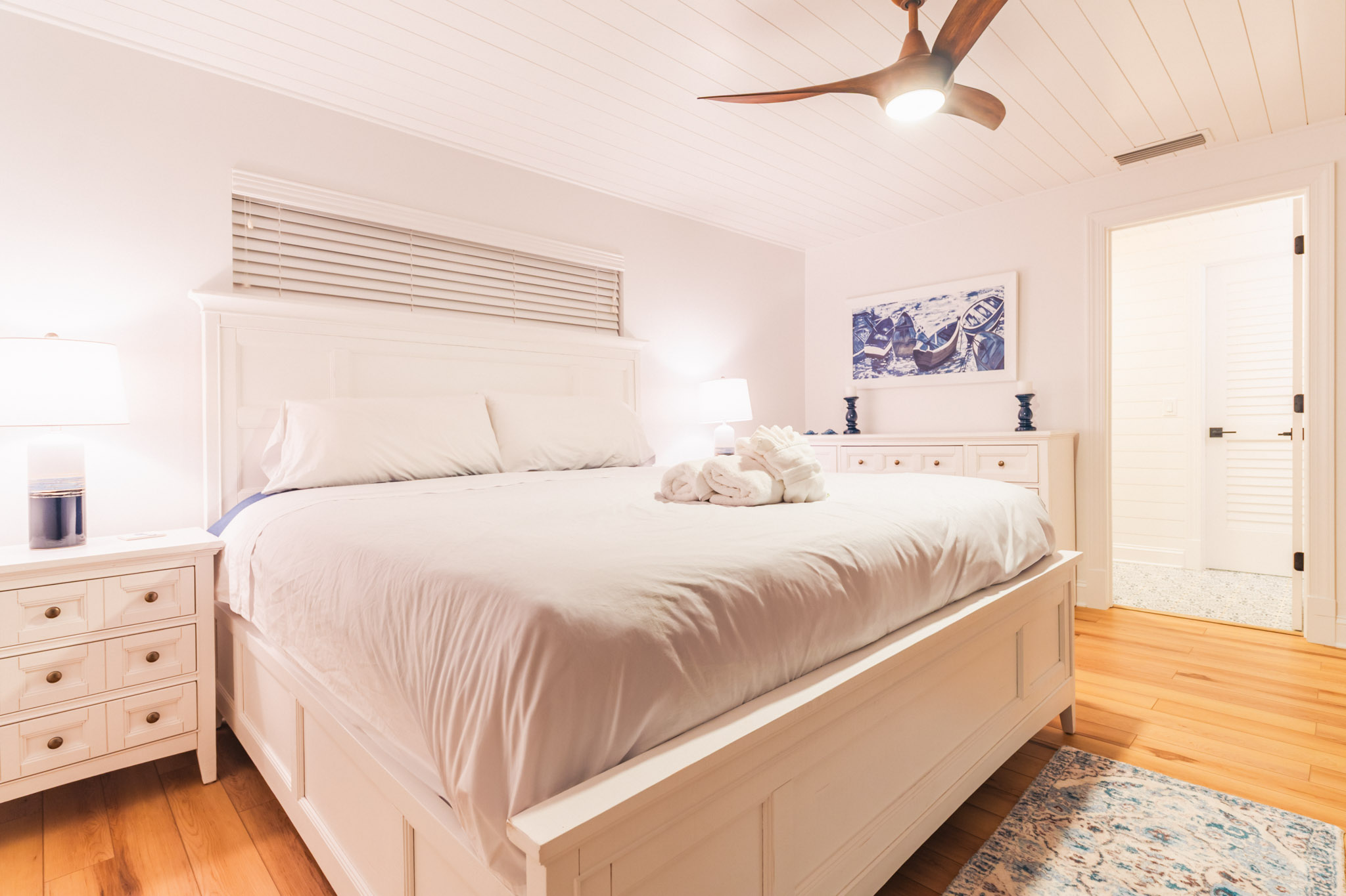 Spacious master suite in Sanibel vacation home with king bed and warm wood floors.