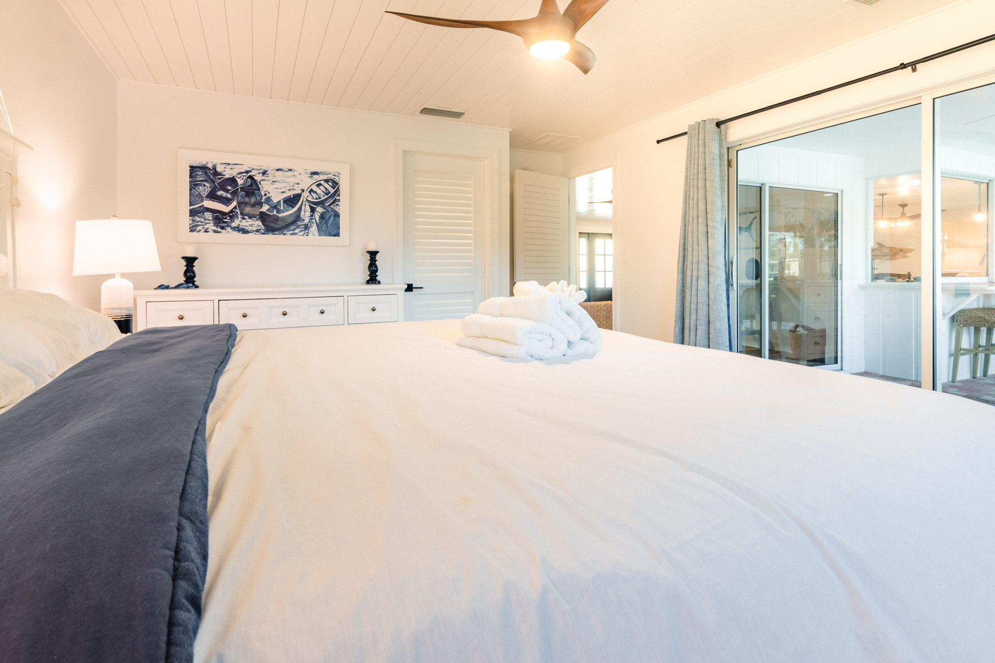 King bedroom with sliding door access to patio in a bright, breezy Sanibel vacation home.