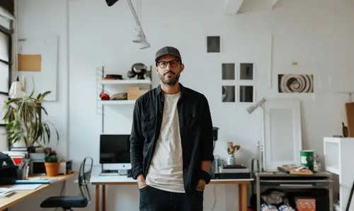 A man standing in front of a desk in a room.