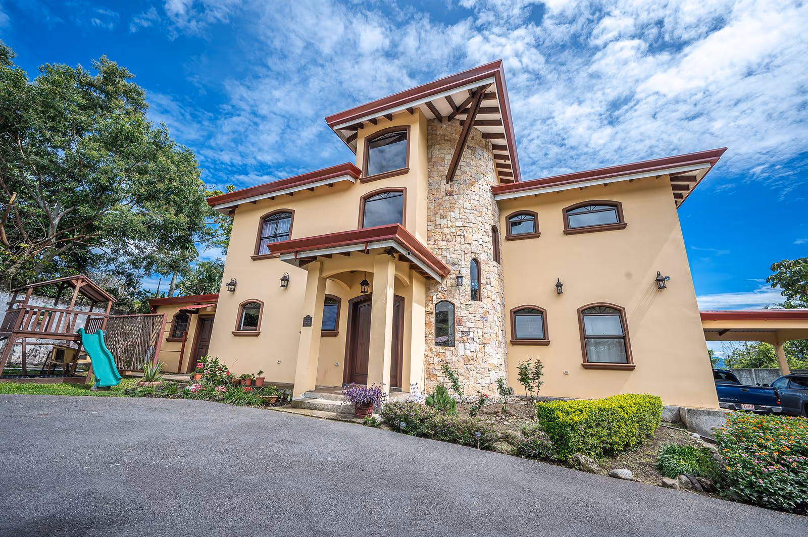 Elegant main entrance of a modern Escazú estate with landscaped walkway and stylish door