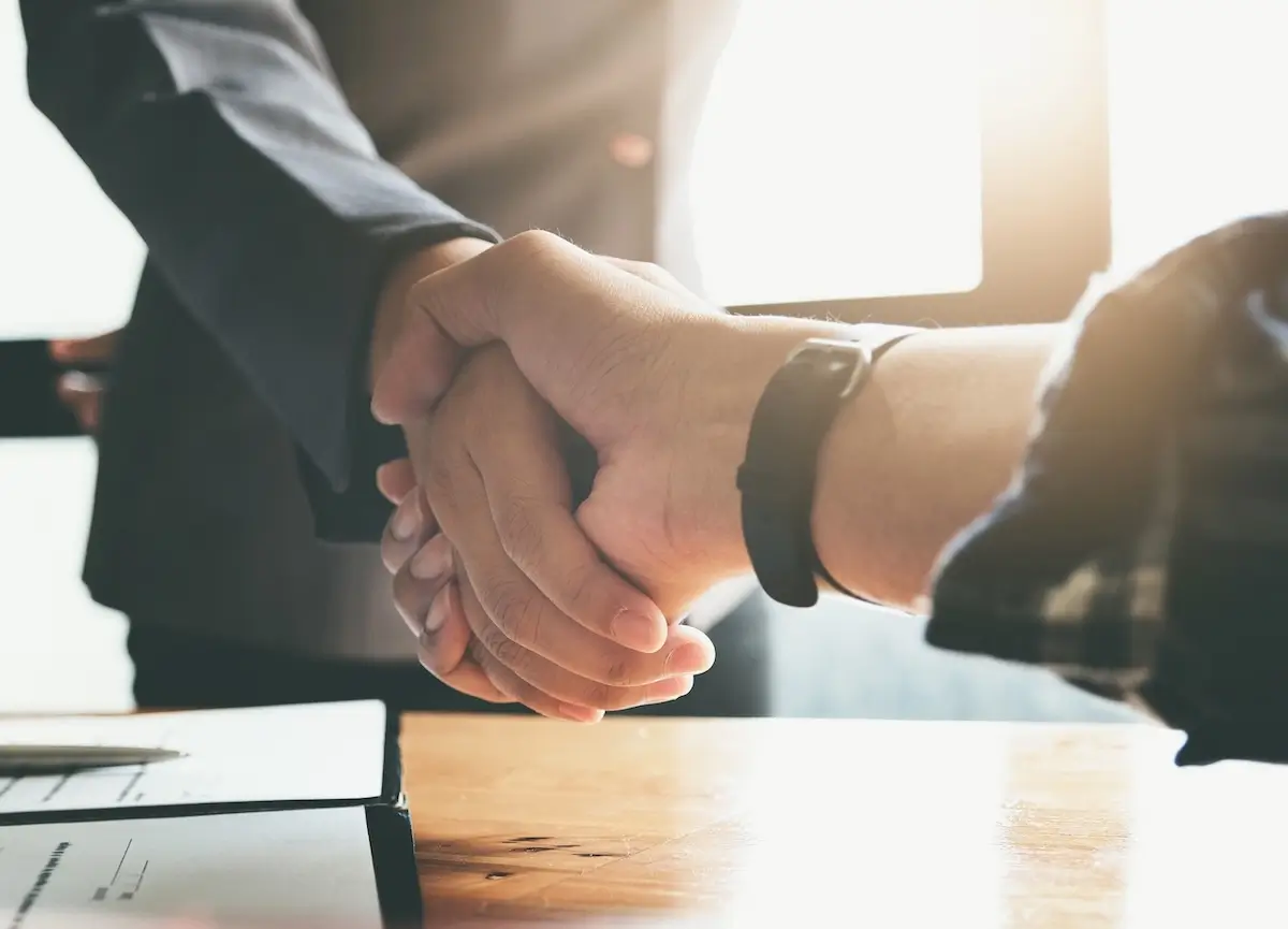 A healthy handshake over a document that was just signed