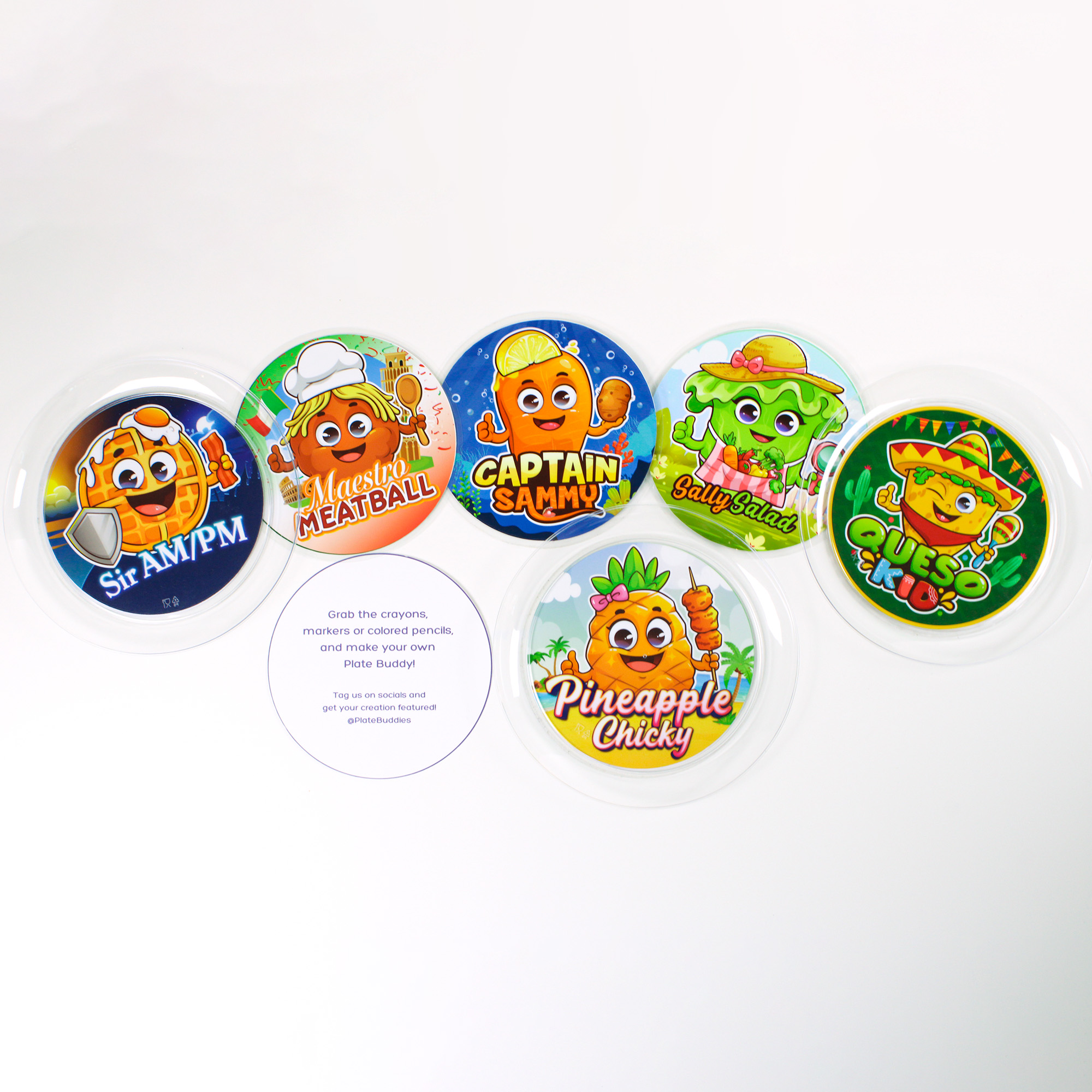 Flat lay of Plate Buddies kids’ mealtime character mats, including Sir AM/PM, Maestro Meatball, Captain Sammy, Sally Salad, Queso Kid, and Pineapple Chicky, displayed on clear plates for picky-eater meal planning.