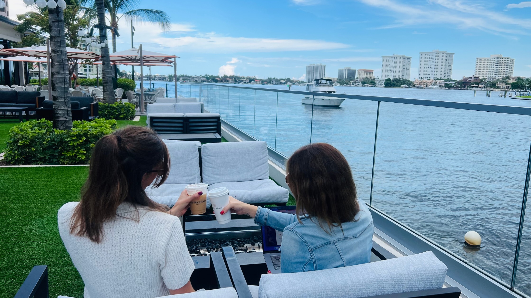 Two women sitting by the water