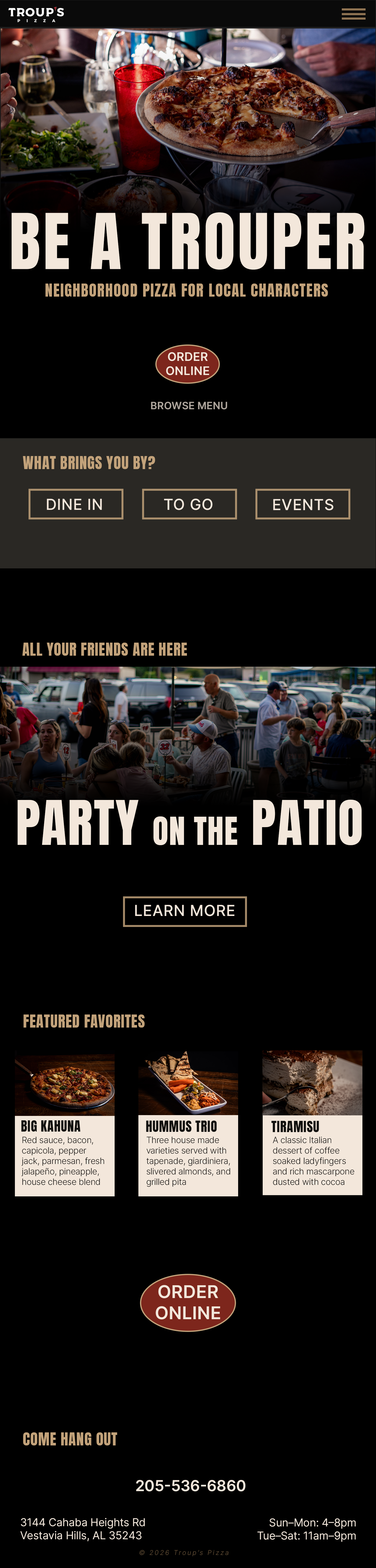 Troup's Pizza homepage featuring a pizza on a stand, options for dine-in, to-go, events, patio dining, and featured menu items Big Kahuna pizza, Hummus Trio, and Tiramisu dessert.