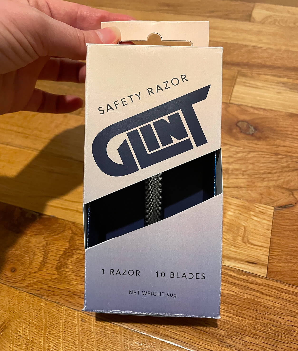 An image of a packaging design for a razor called Glint. 