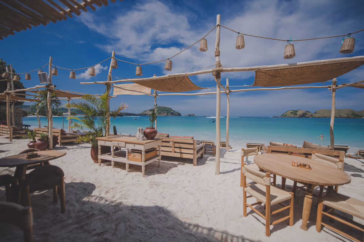 Wide terrace view with natural umbrellas and relaxed guests