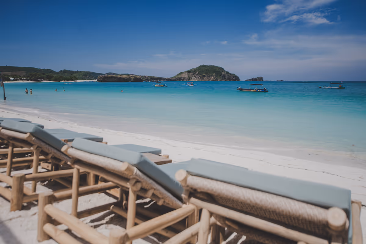 Beachfront chill area with rustic furniture and ocean backdrop.