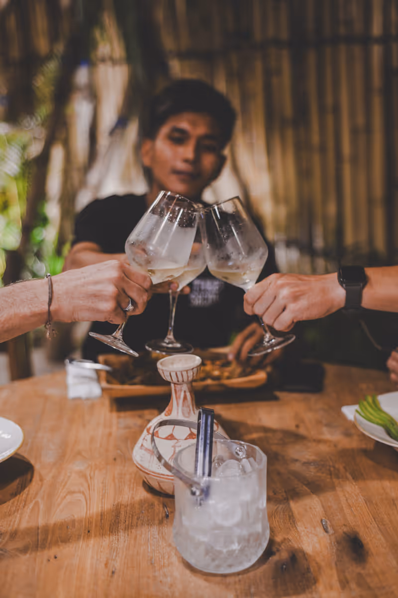 Cheers with wine glasses at night.