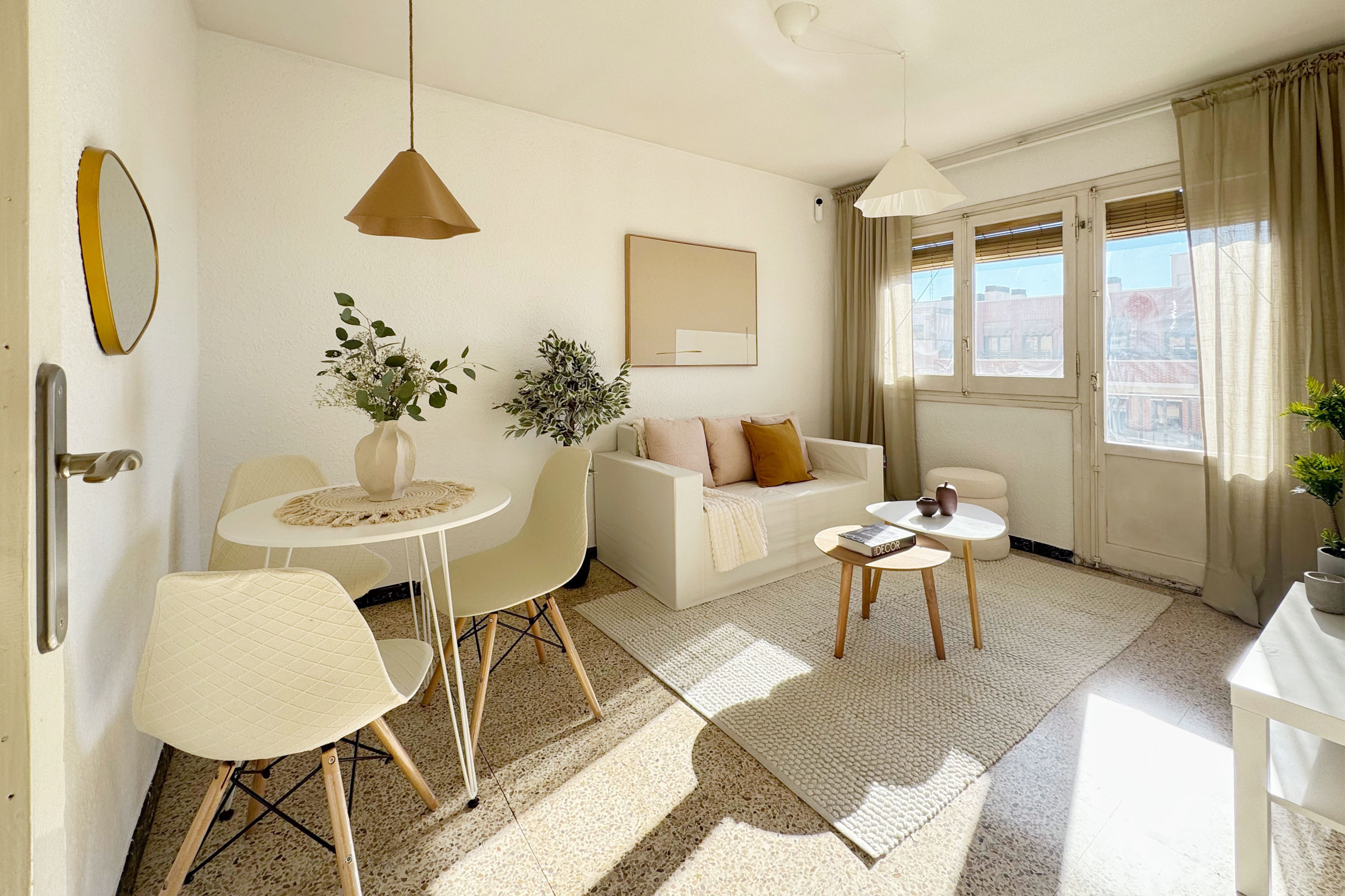 Large bed with chandelier above in bright room