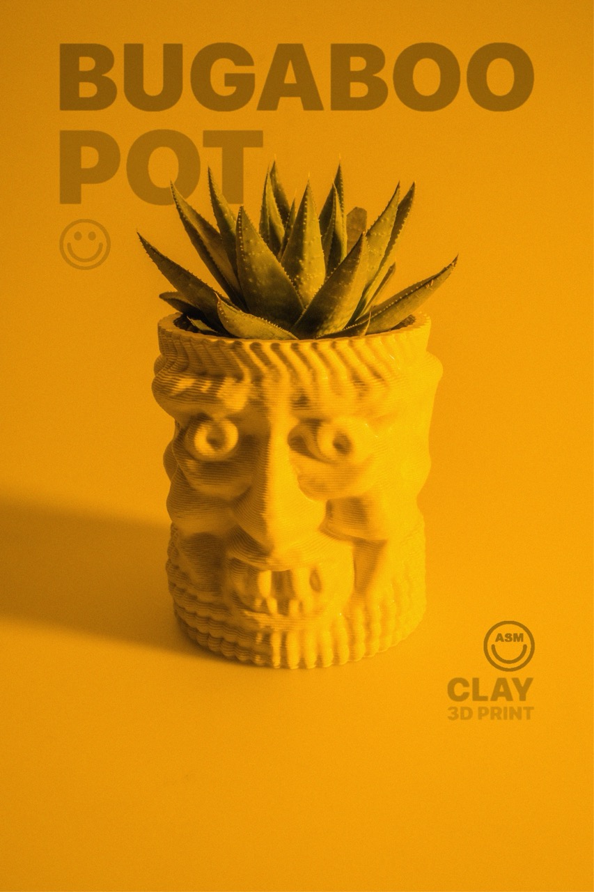 Yellow clay 3D-printed pot shaped like a stylized human face with a green succulent plant inside.