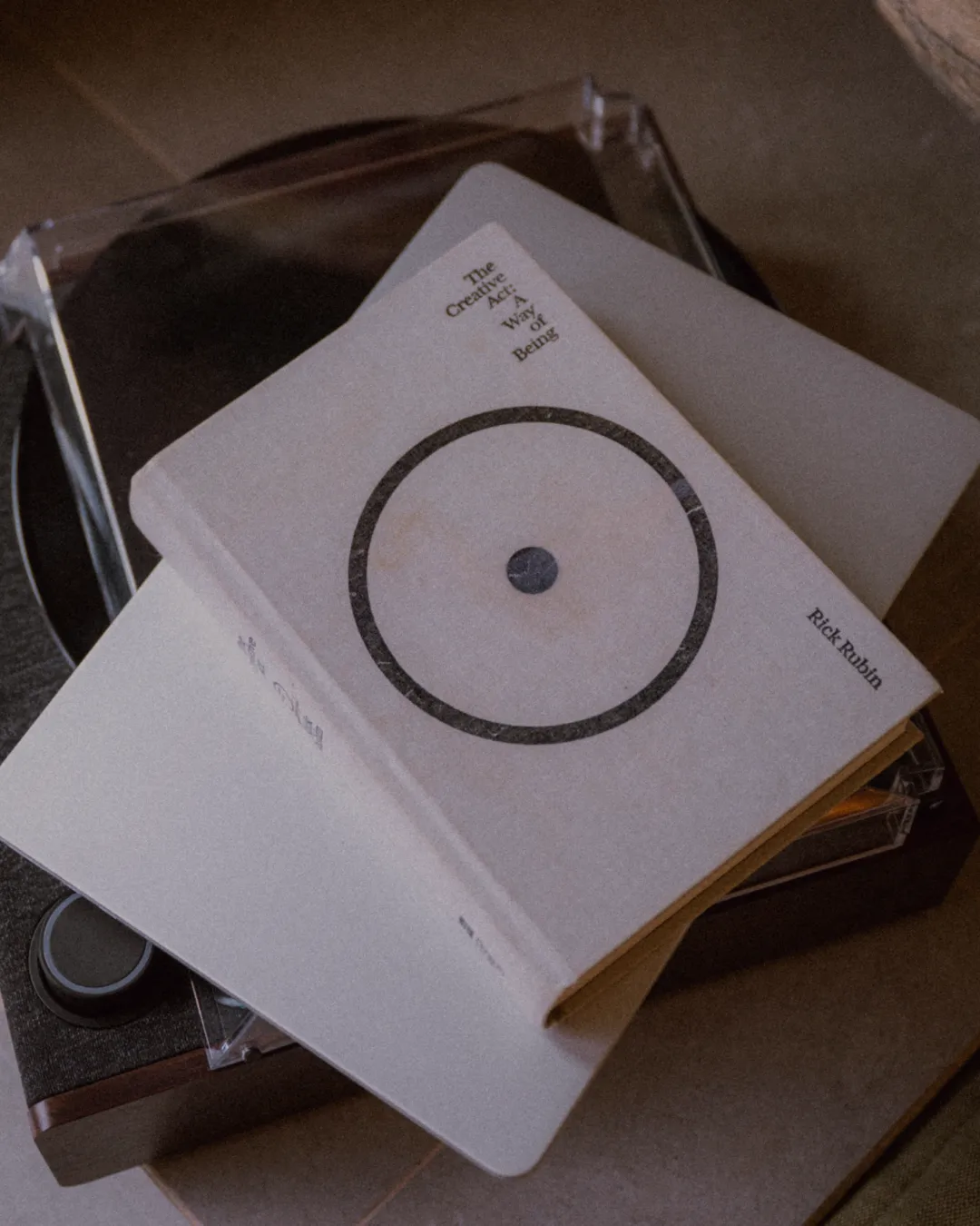 Creative Act by Rick Rubin stacked on laptop and record player