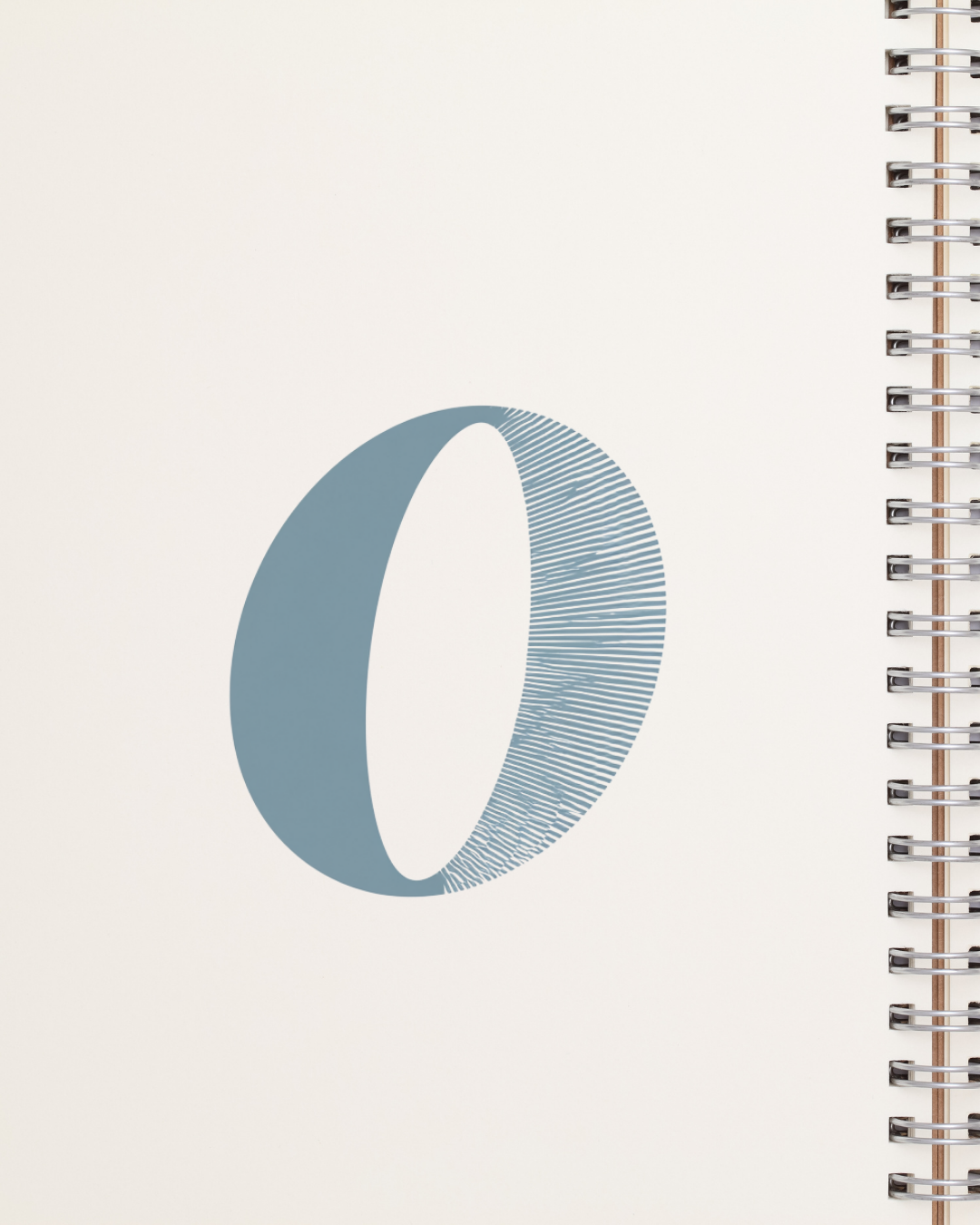 Letterform mark printed on a notebook cover