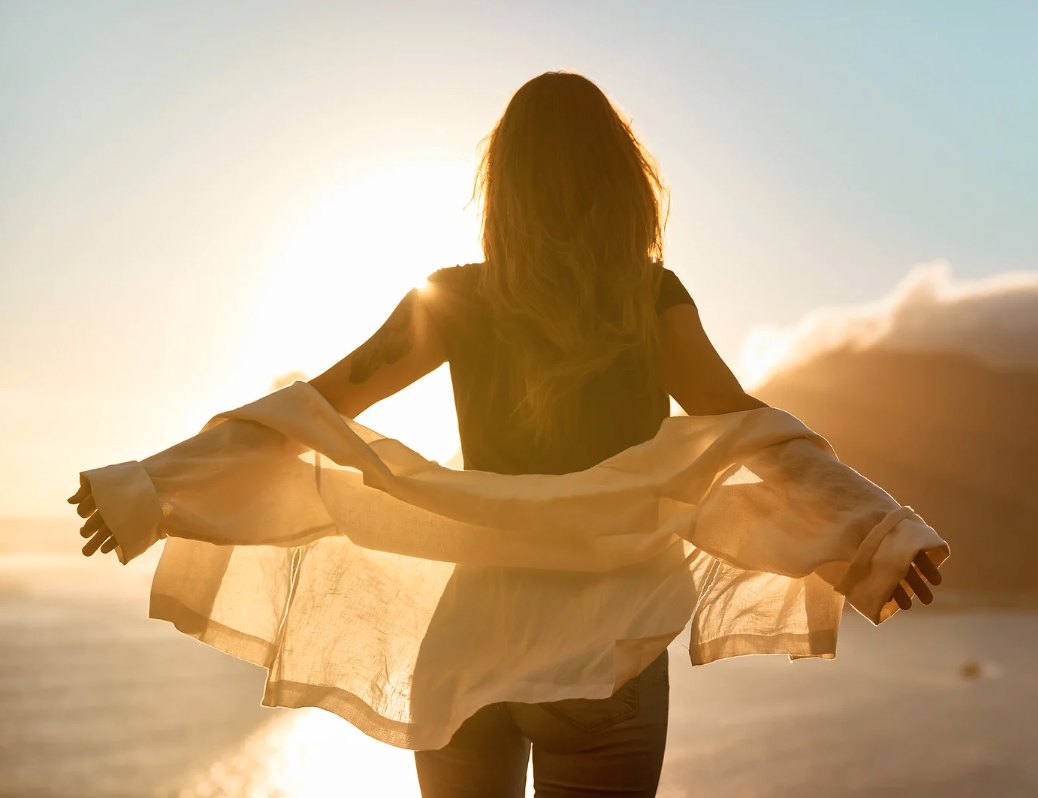 Woman standing at sunset representing lifestyle focused medical weight management