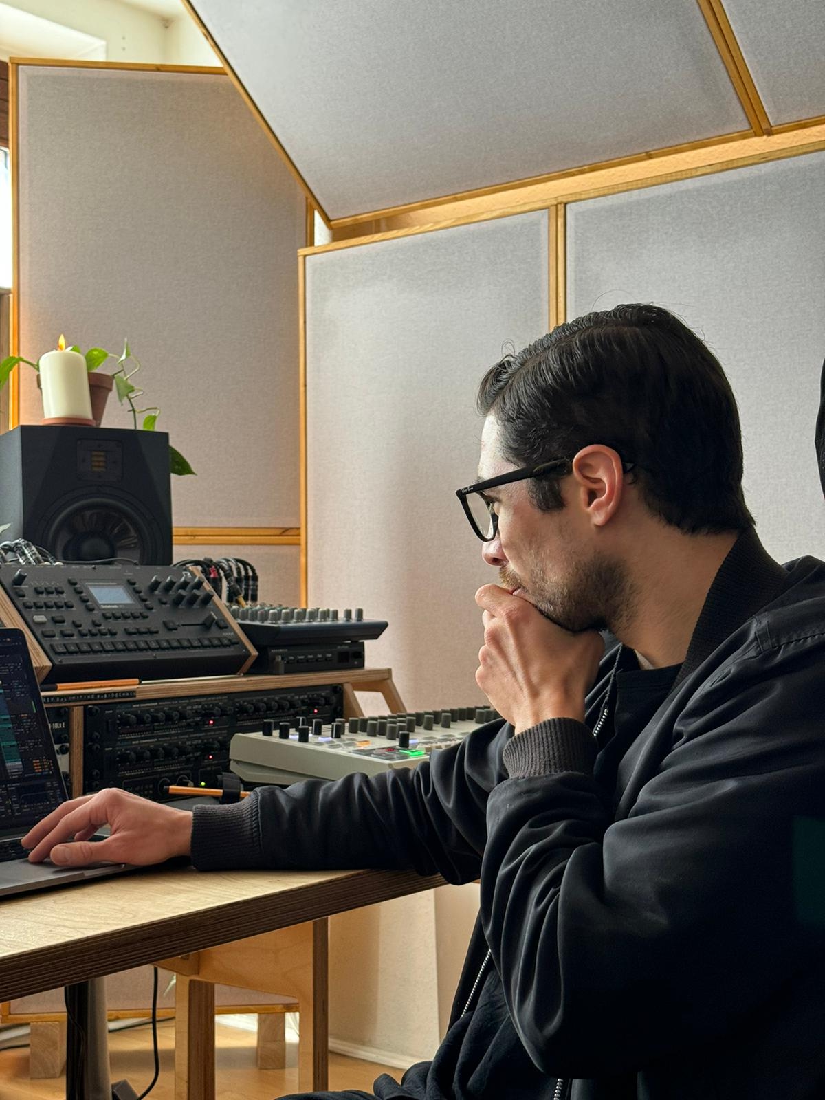 In the studio — focused on crafting sound, surrounded by analog gear and intention.