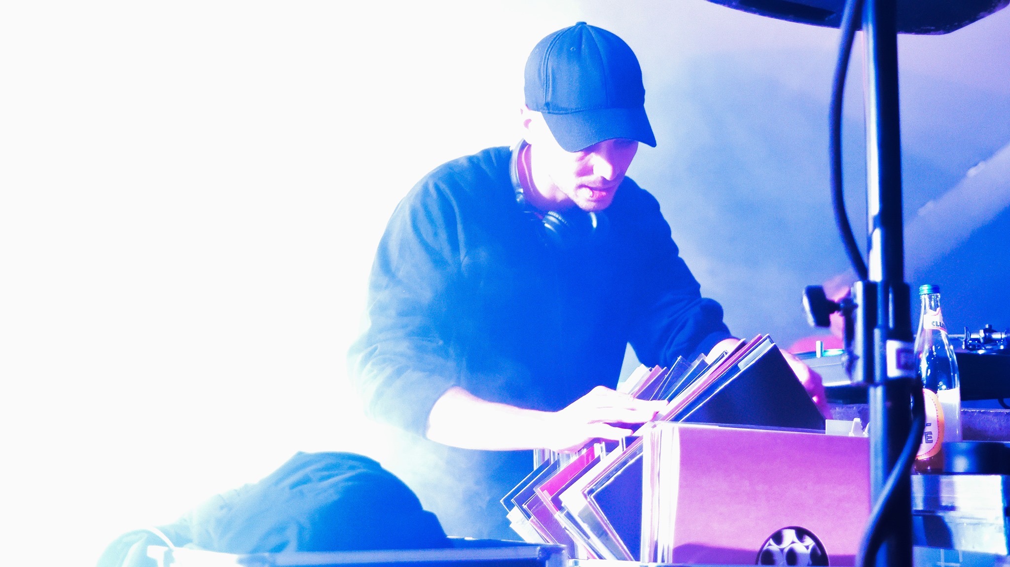 Digging deep—captured mid-search through records during a peak moment in the set.