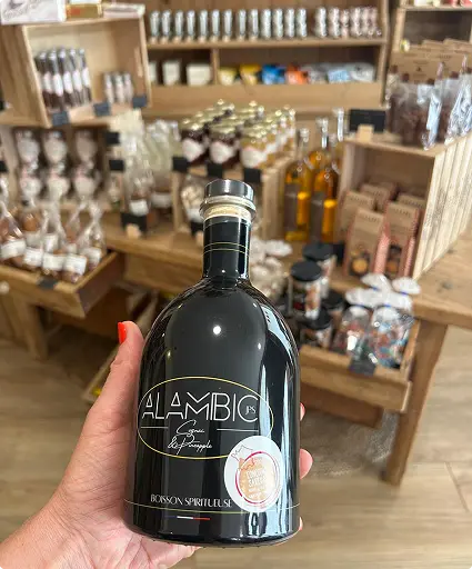 Photo d'une bouteille de Cognac arrangé avec en arrière plan les autres produits de la boutique Au Comptoir de Margot