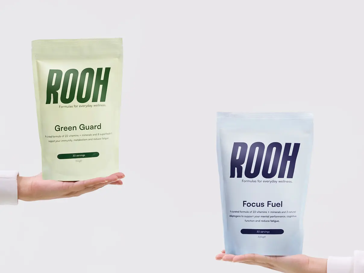 Product shot of two hands, each holding a ROOH formula bag.