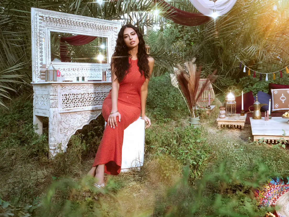 Female model sitting outdoors, in front if a mirror.