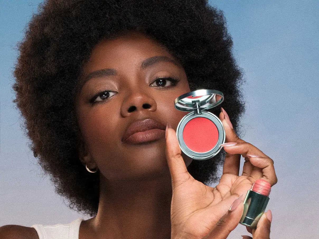Female model holding up an Asteri makeup box.