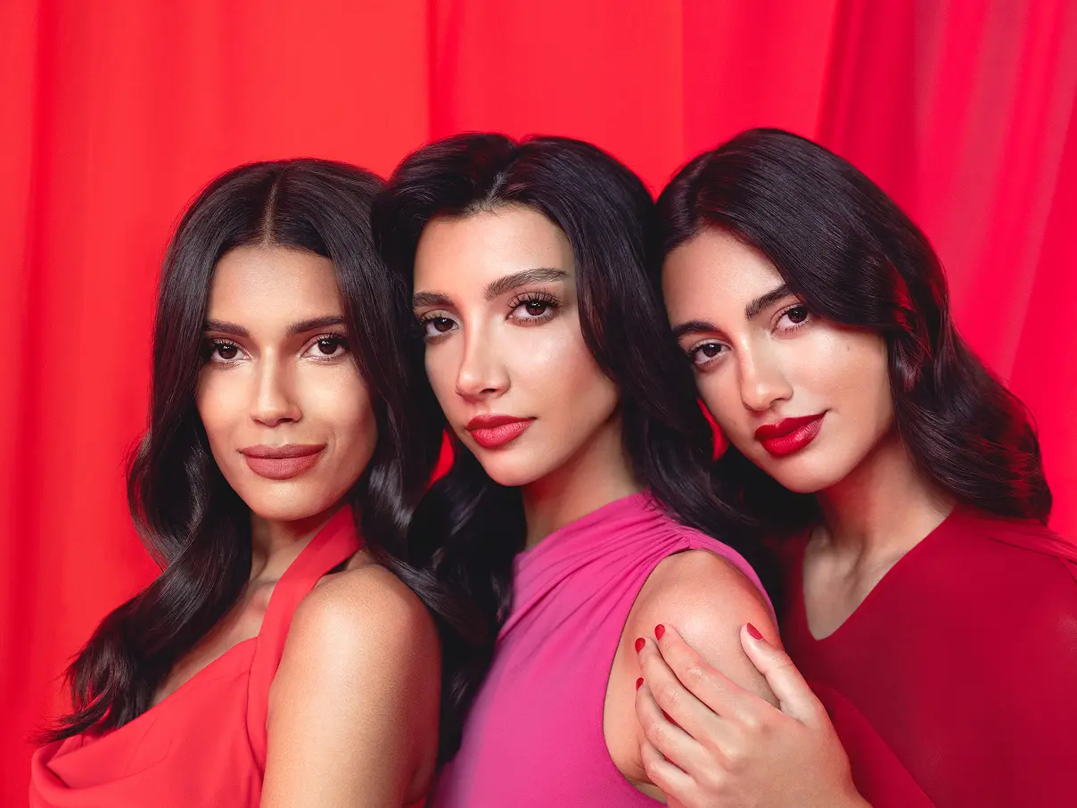 Three female models posing for the camera, wearing Asteri lipstick.