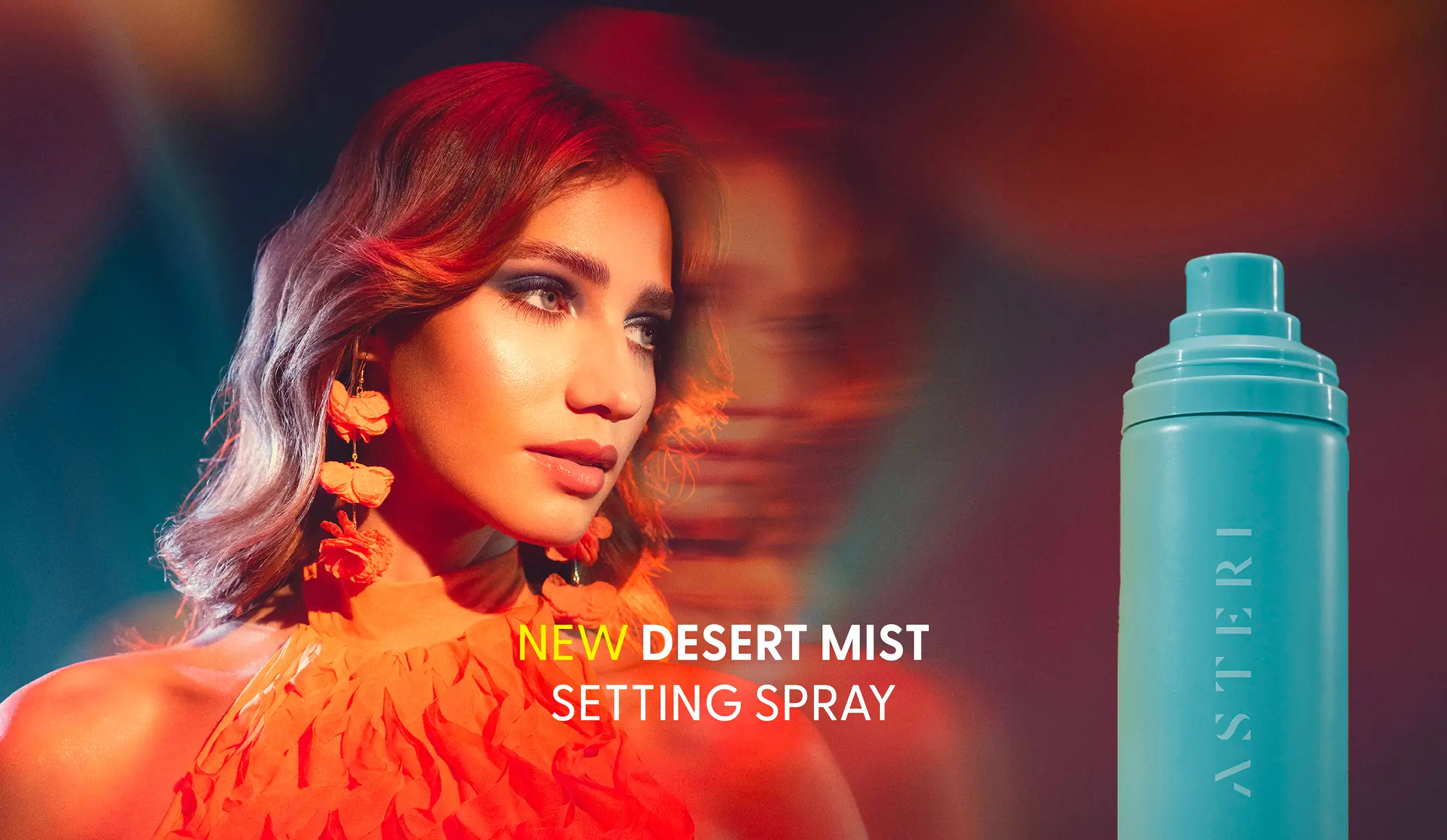 Closeup of a female model. Next to her is a bottle of Asteri dessert mist.