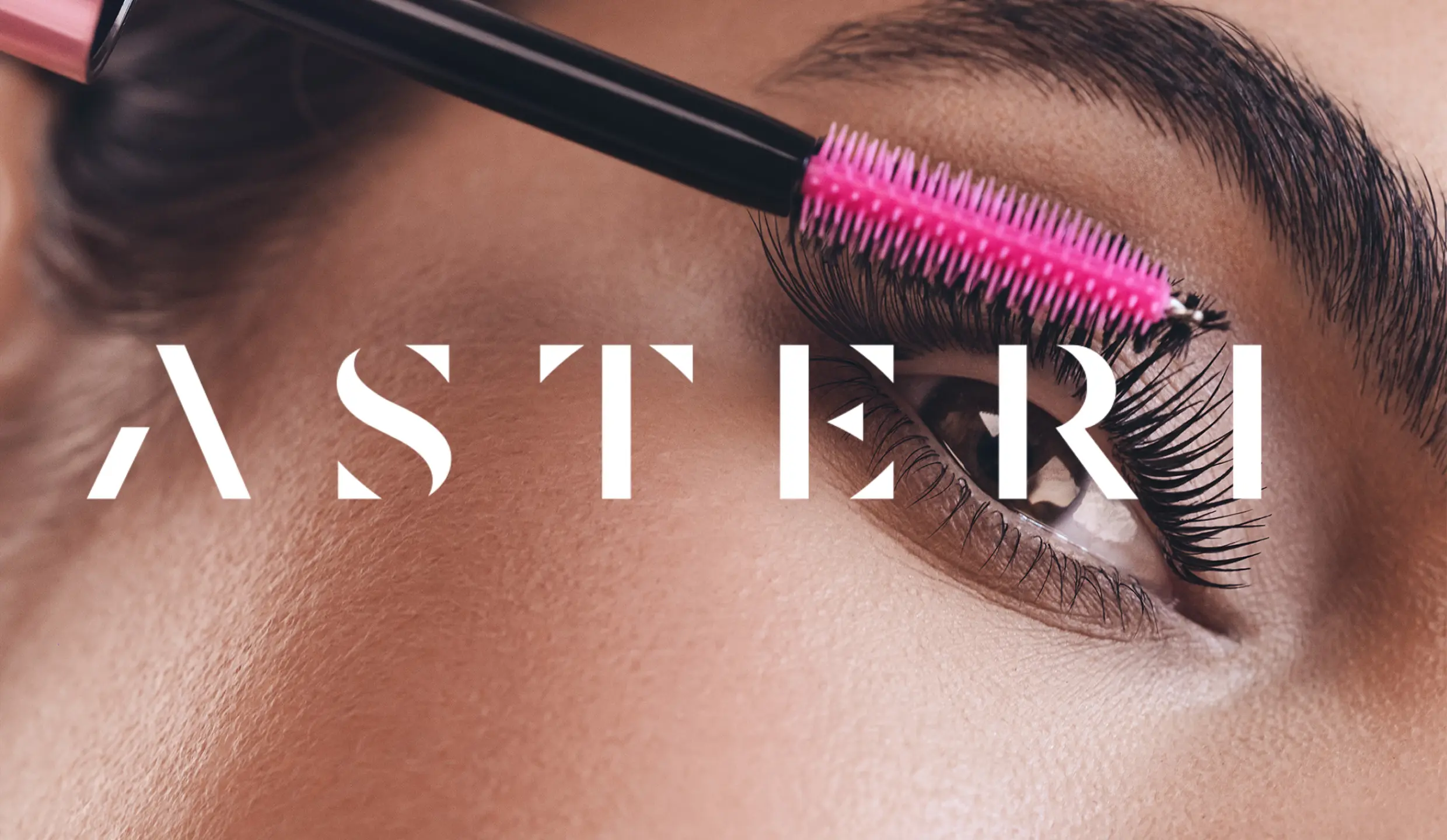 Asteri logo. A woman is applying mascara in the background.