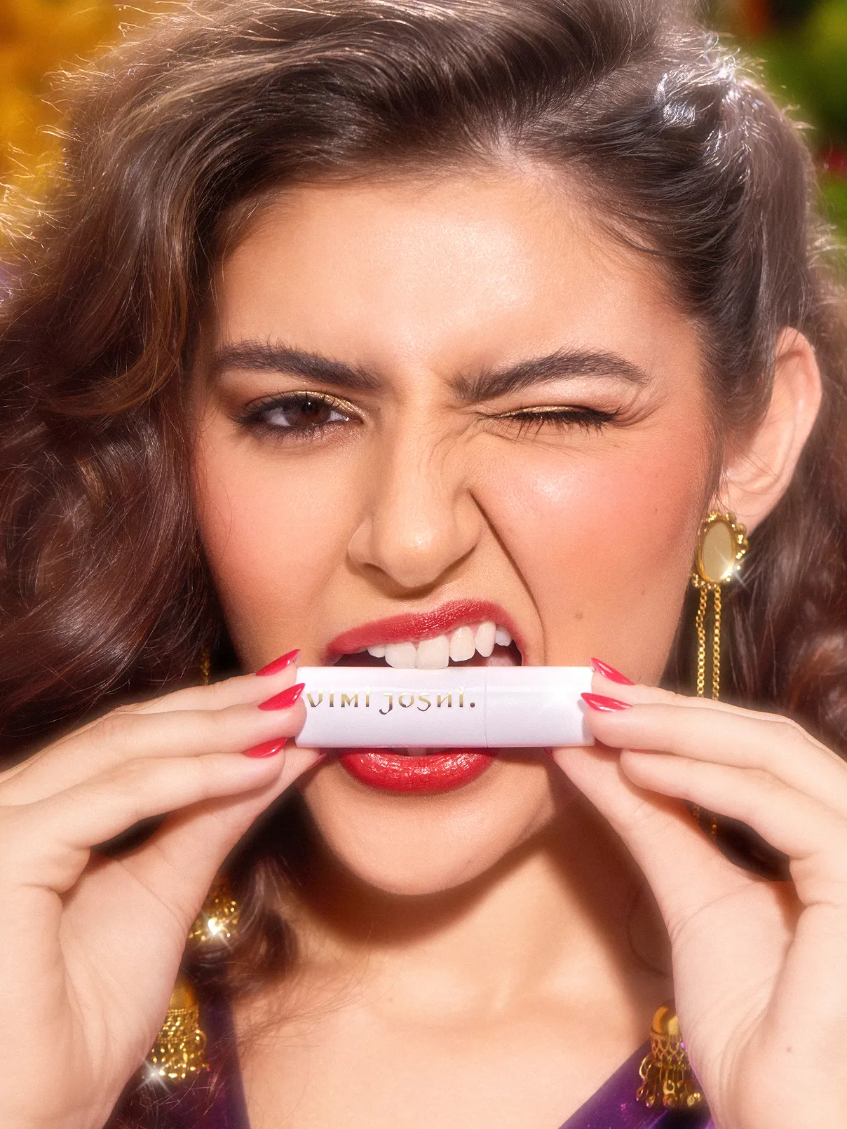 Closeup of a female model  biting a makeup tube