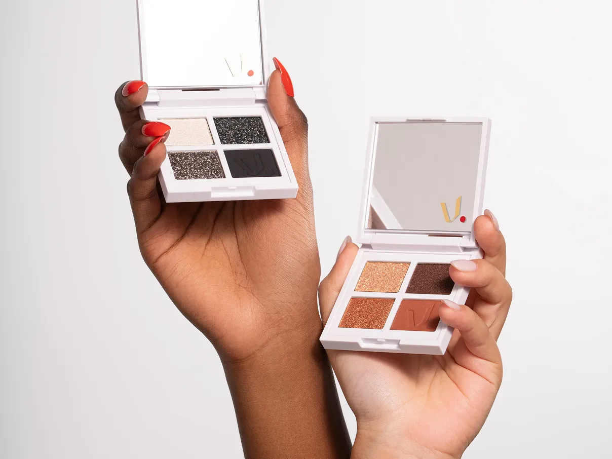 Two hands holding up 2 makeup boxes