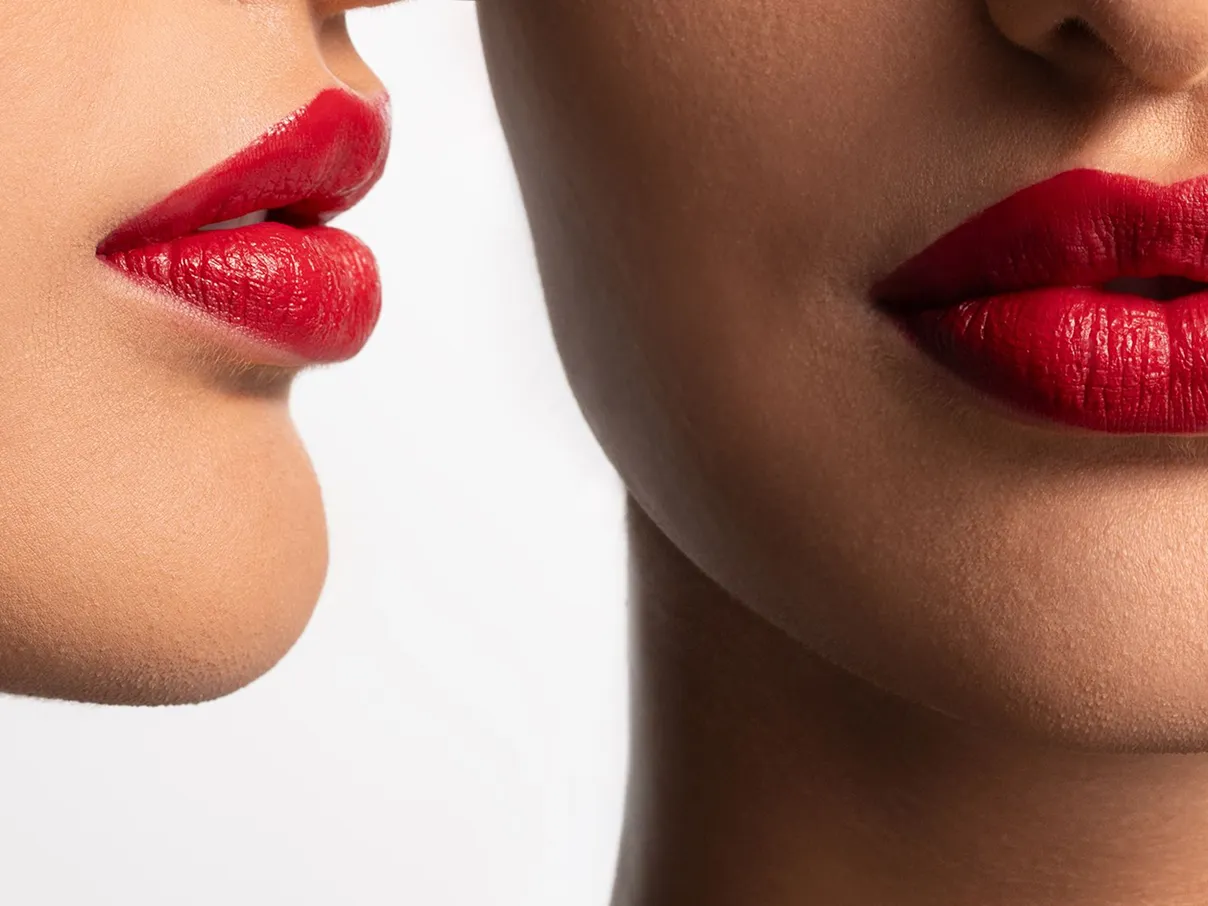 Close up on 2 women faces wearing red lipstick