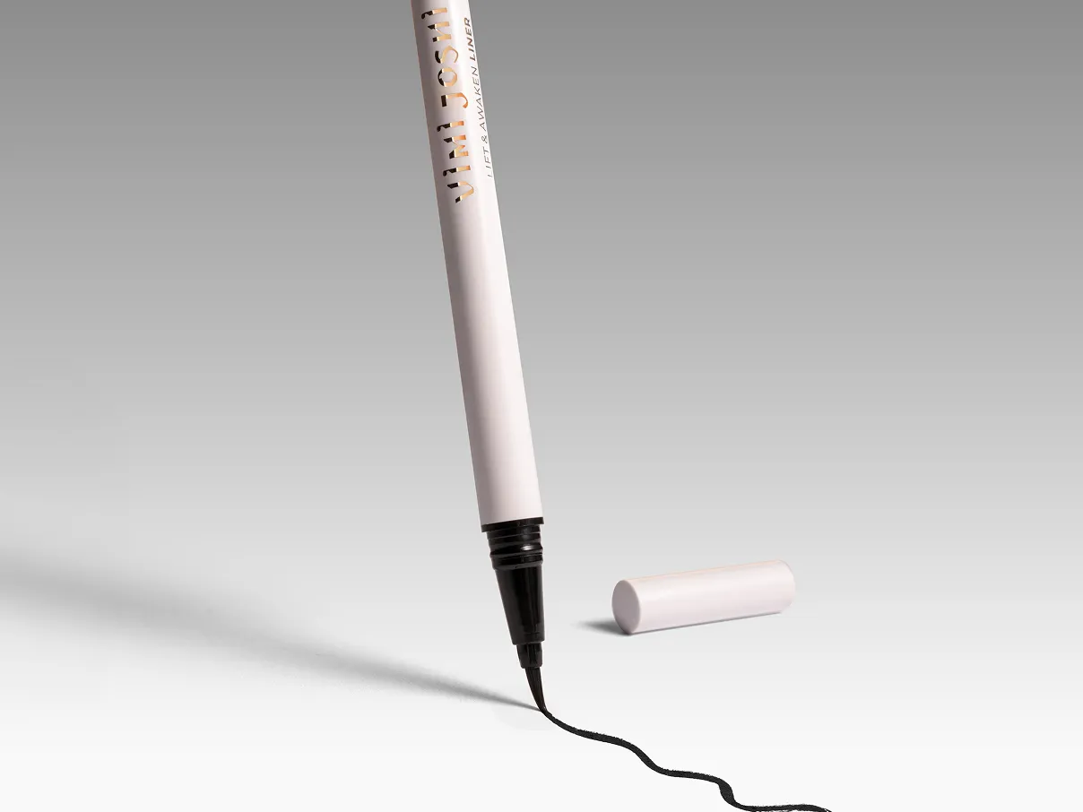 Makeup pencil drawing a dark line on a white surface